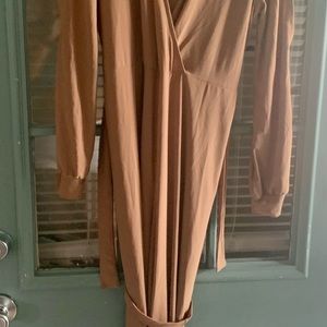 Tan jumpsuit with slit in the arms.